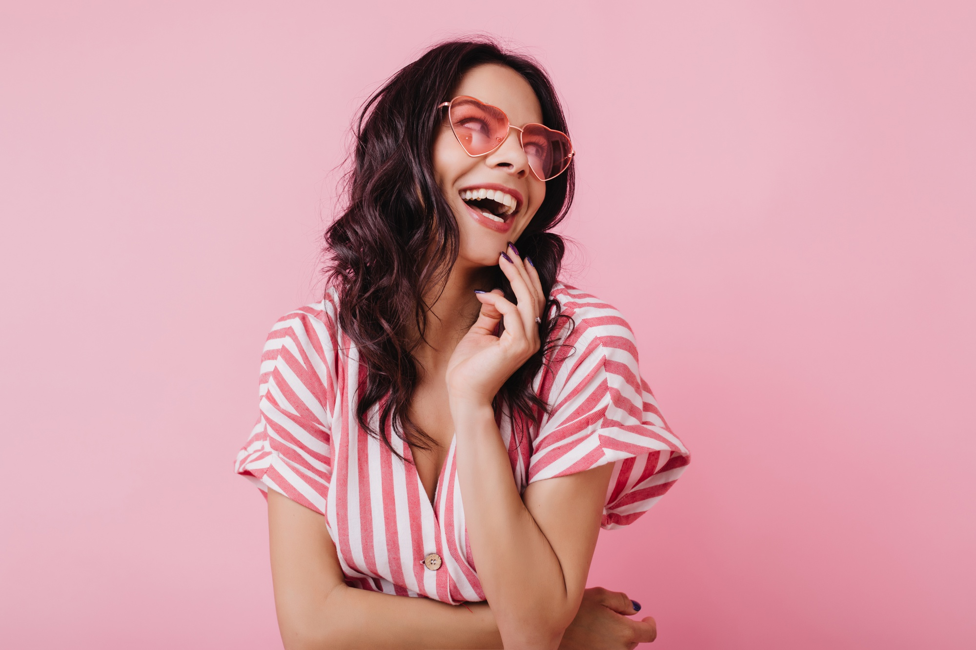 happy-woman-with-wavy-brown-hair-laughing-jocund-girl-in-striped-pink-attire-smiling